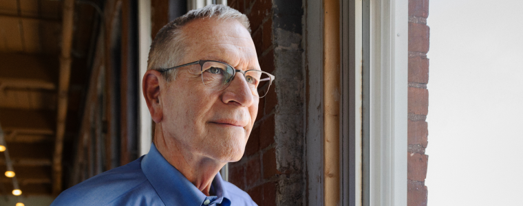 Bill looks out into the distance, a confident smile on his face