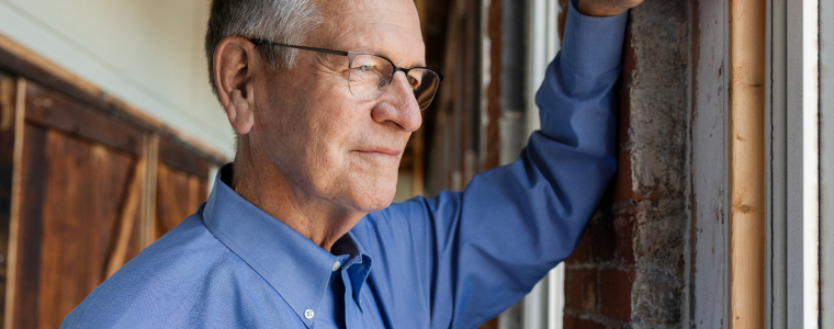 Bill gazes contemplatively out the window